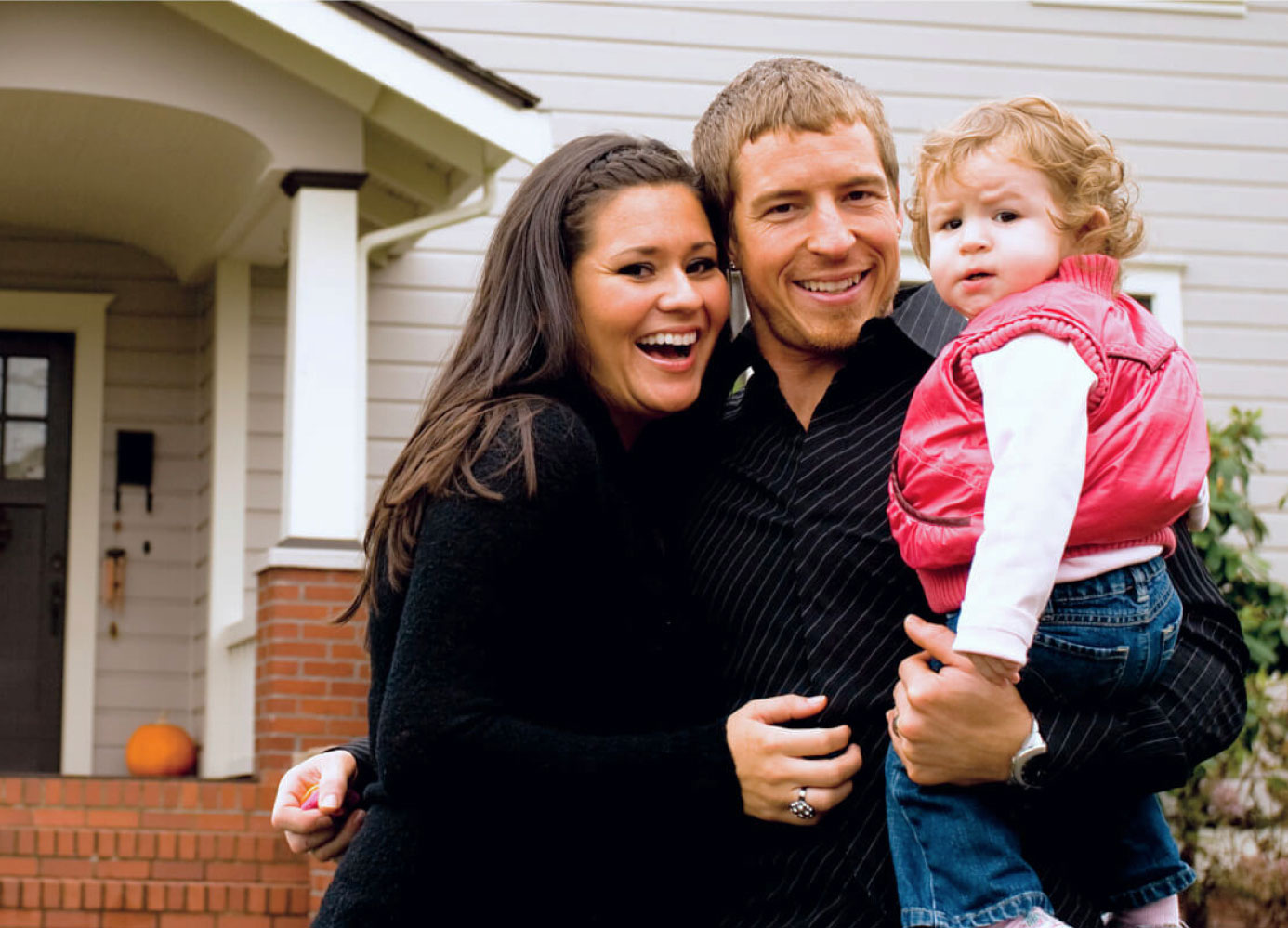 Family in front of home